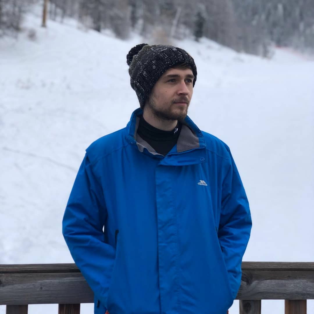 Calum standing with a snowy background